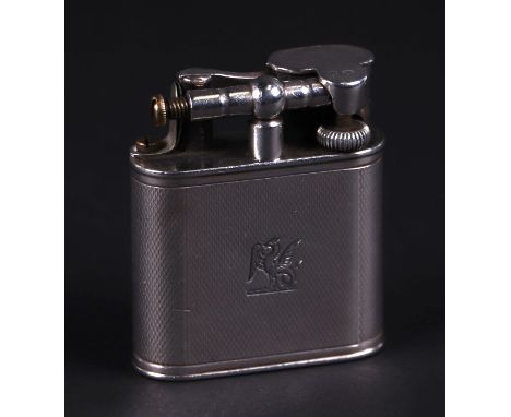 An Alfred Dunhill silver cigarette lighter with armorial and engine turned decoration, registration no.  390107, London 1946,