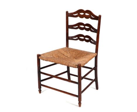 A Lancashire type rush seated dining chair with pierced ladder back.