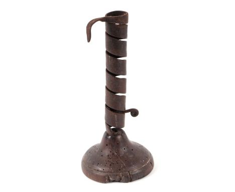 An 18th century steel spiral candlestick on turned wooden base, 19cms high.