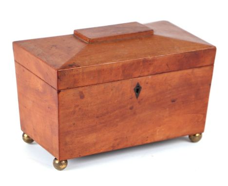 A 19th century satinwood two-division sarcophagus form tea caddy on brass ball feet, 23cms wide.