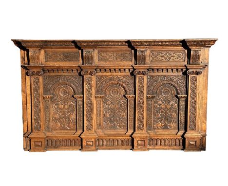 A large carved oak panel incorporating 17th century elements to create an impressive three-panelled panel, 192cms wide.