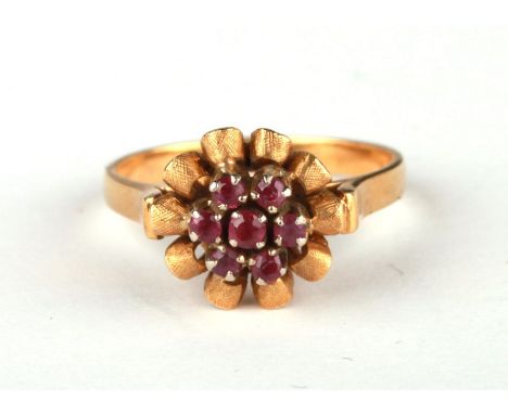 An 18ct gold ruby cluster ring, approx UK size 'O', 5.1g.Condition ReportShank ok, not thin