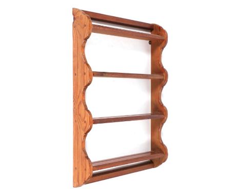 A pitch pine open four-shelf wall hanging plate rack, 65cms wide.