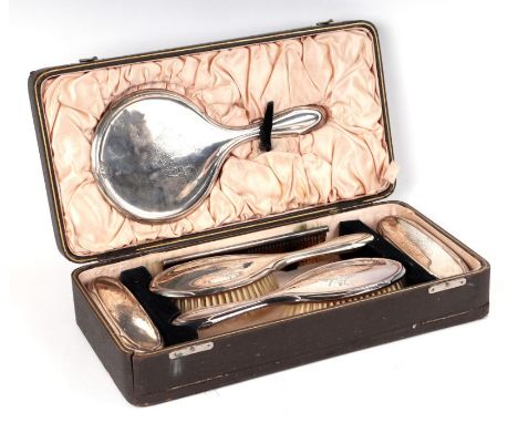 A first quarter 20th century six-piece silver backed dressing table set with engraved decoration, Birmingham 1923, cased.