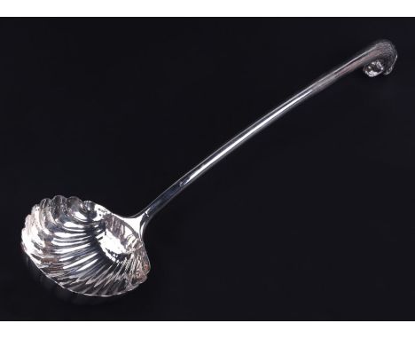 A large 18th century unmarked silver ladle with eagle's head handled terminal and scallop shell bowl (repairs to bowl), 36cms