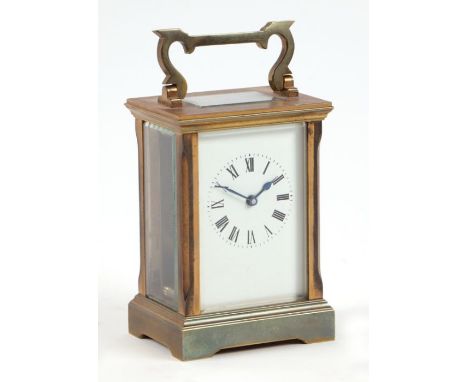 A brass cased carriage timepiece, the white enamel dial with Roman numerals. 12.5cm high