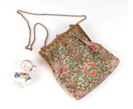 A vintage tapestry purse; together with a porcelain bust of a young girl with paper retail label 'T Good &amp; Co. London' to