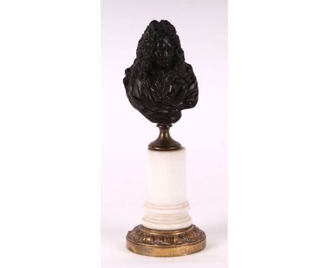 A bronze bust depicting Louis XIV on a marble column, 22cms high.