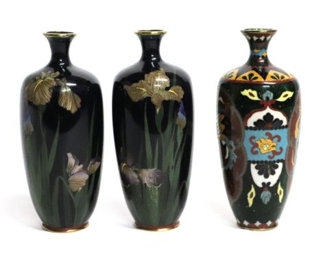 A pair of Japanese cloisonne vases decorated with irises on a midnight blue ground, 15cms high; together with another cloison