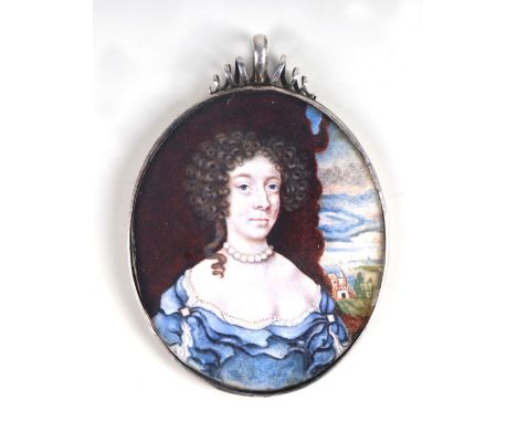 A 17th century white metal framed portrait miniature of a lady wearing a blue dress with a country house in the background, c