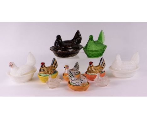 A group of ceramic and glass hens on nests to include two milk glass examples, largest 14cms wide (10).