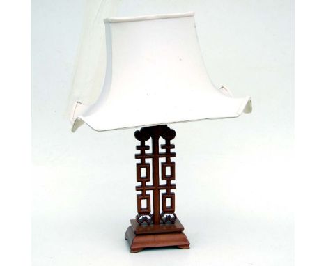A Chinese hardwood table lamp, 56cms high including shade.