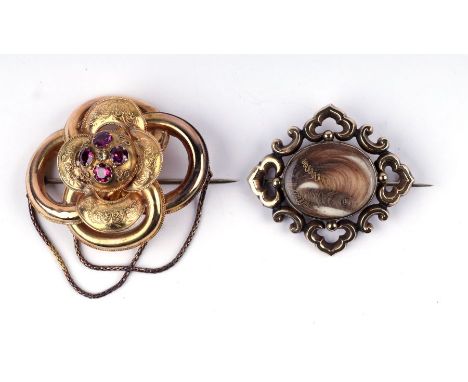 A mid Victorian yellow metal ornate knot brooch set with four old cut garnets and central diamond, 4.5cms wide, 10.6g; togeth