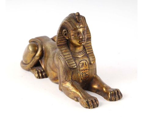 A Victorian Egyptian Revival Grand Tour bronze figure of a Sphinx, 26cms long.