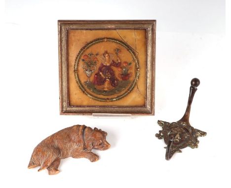A 19th century German wax portrait in relief, framed, 14 by 14cms; together with a Black Forest style carved wooden dog with 