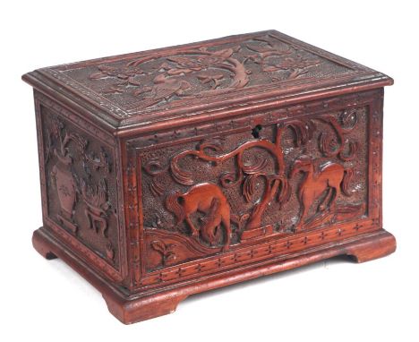 A Chinese carved wooden single compartment tea caddy, the panels carved depicting scenes of birds, horses and precious object