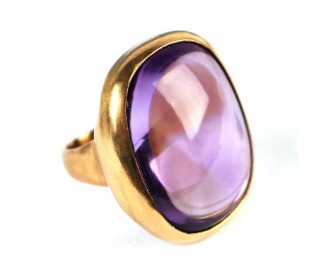 A French 18ct gold and large cabochon amethyst ring, the single stone measures approx 30 by 23 by 14mm which gives an approxi