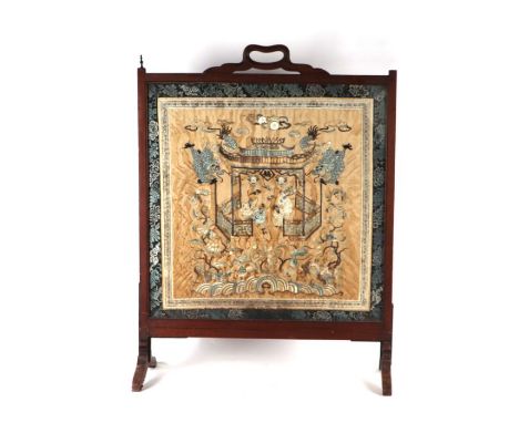 A Chinese hardwood firescreen with inset silk embroidered panel depicting figures, dragons, birds and flowers, overall 65cms 