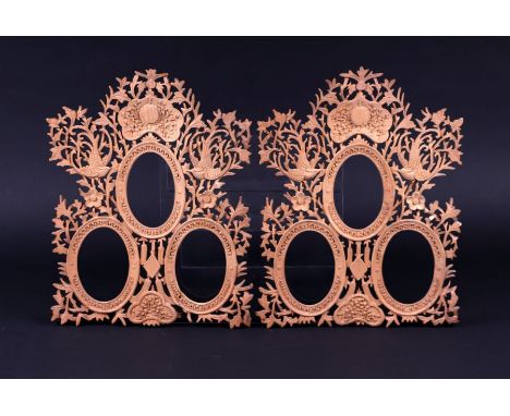 A pair of Chinese carved wood triple portrait miniature frames with bird and foliage decoration, 23cms wide (2).