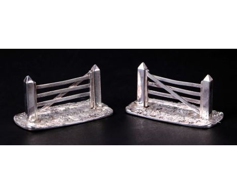 A pair of novelty silver plated knife rests in the form of five bar gates, 8cms wide.Condition Report4cms high, light wear to