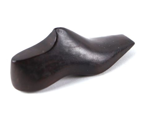 A 19th century treen cotton winder in the form of a shoe, 7cms long; together with a carved treen nut cracker, 33cms long.