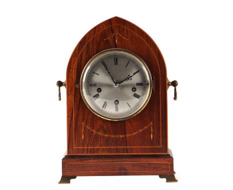 An Edwardian mantle clock, the silvered dial with Roman numerals and fitted with a three-train movement striking on four gong