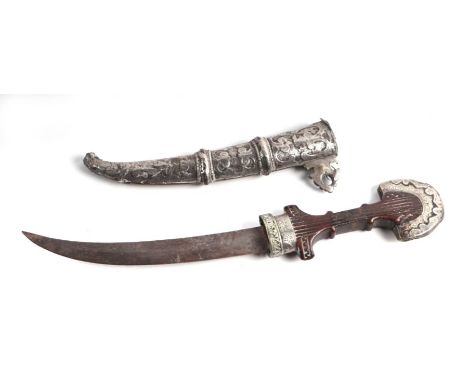 A Middle Eastern dagger with white metal mounted hardwood grip, curved blade, in a white metal scabbard, 39cms long.