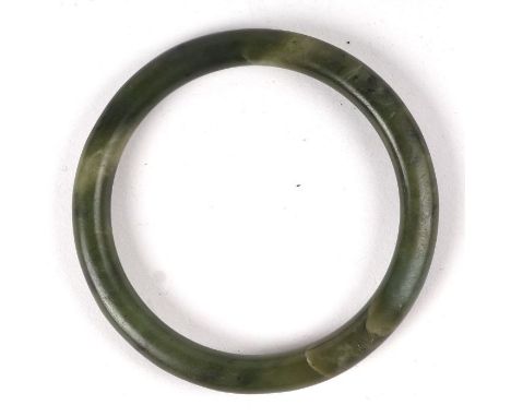 A jade / hardstone bangle, 8cms diameter.