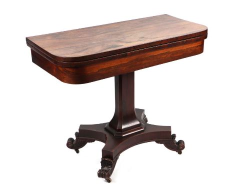 A Regency rosewood card table, the rounded rectangular fold-over top above an architectural column, on a quatrefoil base with