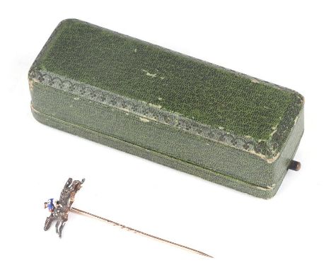 A Victorian yellow metal diamond and enamel stick pin in the form of a jockey riding a racehorse, with an engraved scroll ben