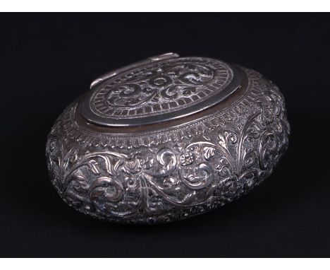 An Indian white metal snuff box with scrolling foliate decoration, 7cms wide, 75g.