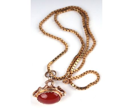 A 9ct gold pocket watch fob mounted with an oval carnelian cabochon on a heave 9ct gold box link chain, total weight 16.8g.
