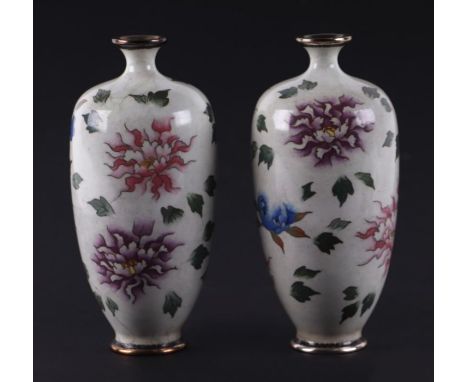 A pair of Japanese cloisonne vases decorated with flowers on a pale grey ground, 15cms high (2).Condition ReportGood overall 