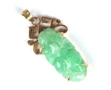 A Chinese yellow metal mounted jade pendant, 3cms high.