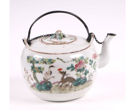 A 19th century Chinese famille rose teapot decorated with a deer, a red capped crane and flowering foliage, with peach finial