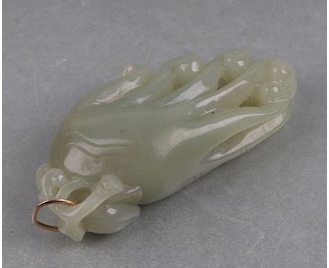 A Chinese pale celadon green jade carved pendant of a finger citron of Buddha's hand, 7.5cms long.