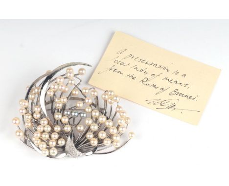 A large silver and cultured pearl peacock brooch purportedly presented by the Ruler of Brunei, in a Hiramatsu box, 9cms wide.
