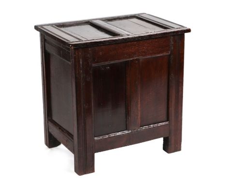 A 17th century oak coffer with twin front panel, on stile legs, reduced in length, 65cms wide.