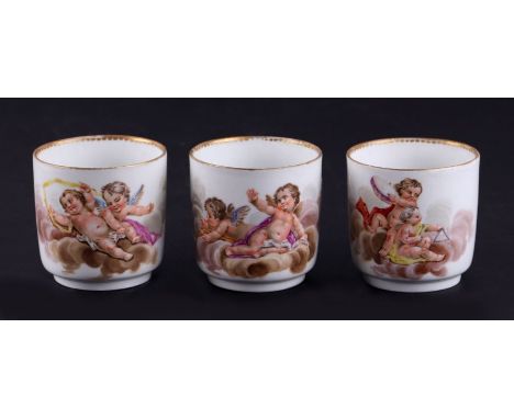 Three Meissen coffee cups, each decorated with cherubs at play, 6cms high (3).Condition ReportThe first cup has had the gilt 
