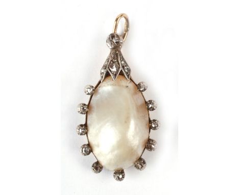 A yellow metal mounted diamond set baroque pearl pendant. 3.5cm high