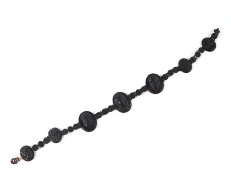 A Grand Tour style carved lava necklace, each panel carved with a classical figure, 42cms long.