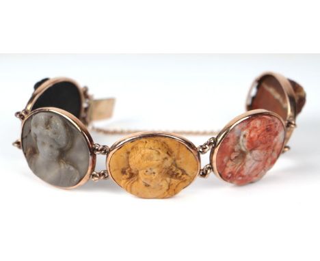 An antique five panel bracelet, each panel decorated with a female figure carved in high relief, in a later yellow metal moun