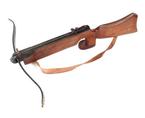 A crossbow with hardwood stock and leather shoulder strap, 80cms long.