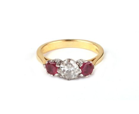 An 18ct gold three stone diamond and ruby ring, the central diamond approx 1ct flanked by two rubies, approx .5ct, approx UK 