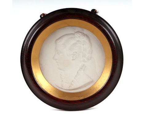 A Victorian plaster plaque depicting a bust portrait in relief of a young woman, signed 'C B Birch', glazed and in an oak fra