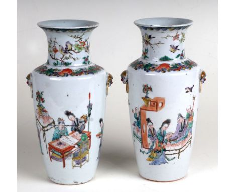 A pair of Chinese famille vert vases decorated with figures at work, with moulded maks ring handles, each 23cms high (2).Cond