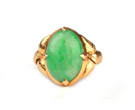 A Chinese high carat gold ring set with an apple jade cabochon, approx UK size 'M'.Condition ReportThe stone measures 15 by 1