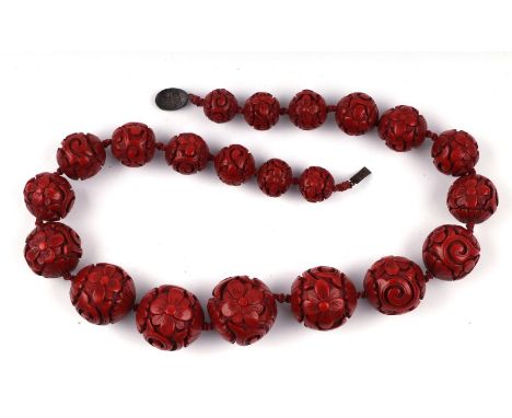 A fine Chinese carved cinnabar lacquer graduated ball necklace with silver clasp (clasp a/f).Condition ReportThe largest bead