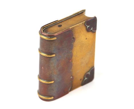 A WW1 trench art lighter in the form of a miniature book, made from brass and copper. 5.5cms (2.125ins) high by 4.5cms (2.75i