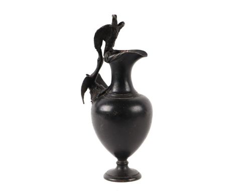 A 19th century cast bronze Grand Tour ewer, the handle in the form of a swan with outstretched wings and a bird of prey surmo